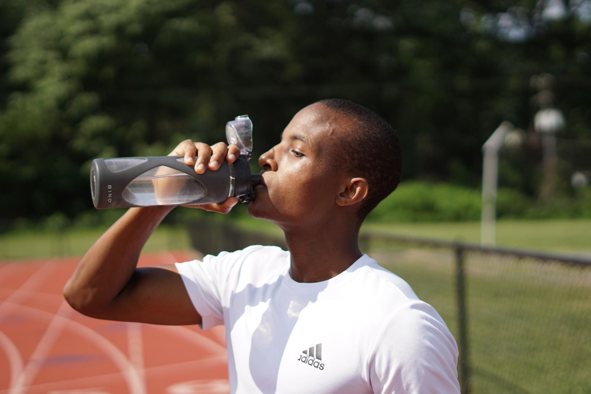 Fitness Woman Drinking Water, Outdoor. Athletic Girl Quenches