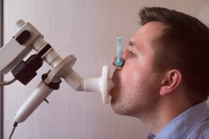 Man breathing into a spirometry machine