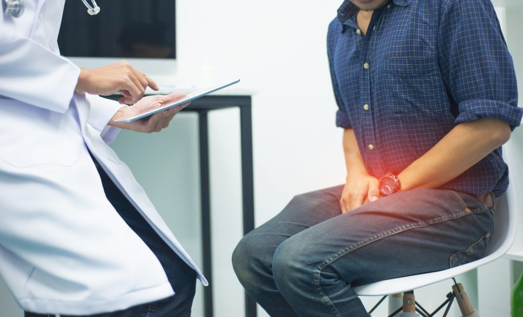 man with pain in private area at doctor's appointment