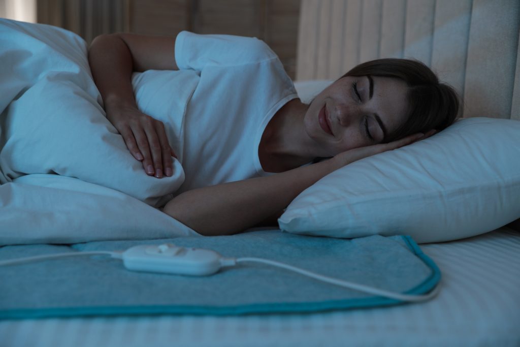 woman sleeping with heating pad