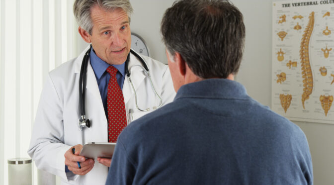 Doctor asking older patient questions.